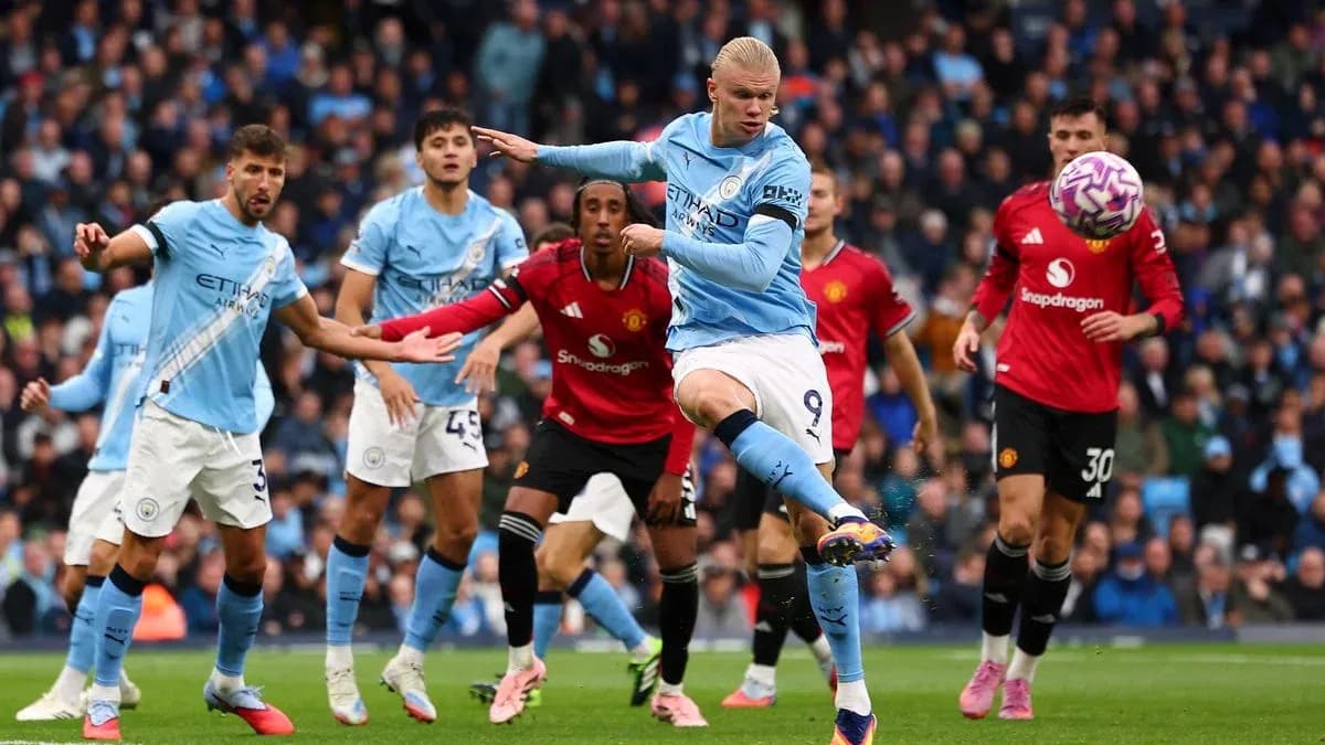 Erling Haaland striking the ball during Manchester derby