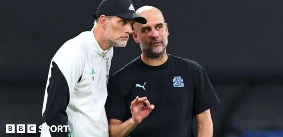 Two football managers discussing strategy on the sidelines