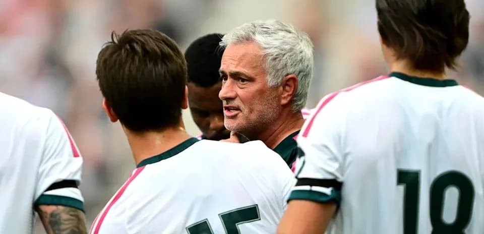 Manager discussing tactics with players during match