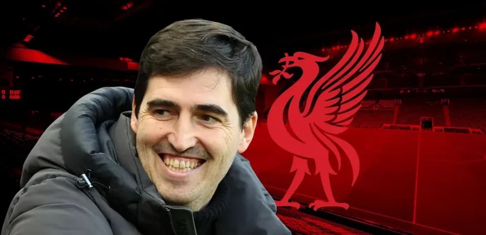 Man smiling in front of Liverpool stadium backdrop