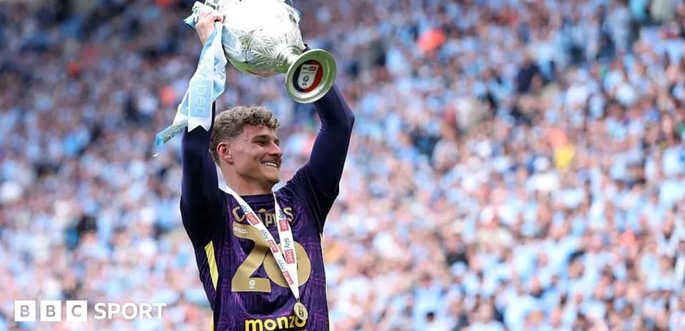 Player celebrating with trophy at victory ceremony