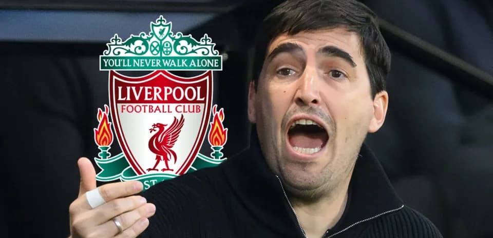Person gesturing passionately near Liverpool FC logo