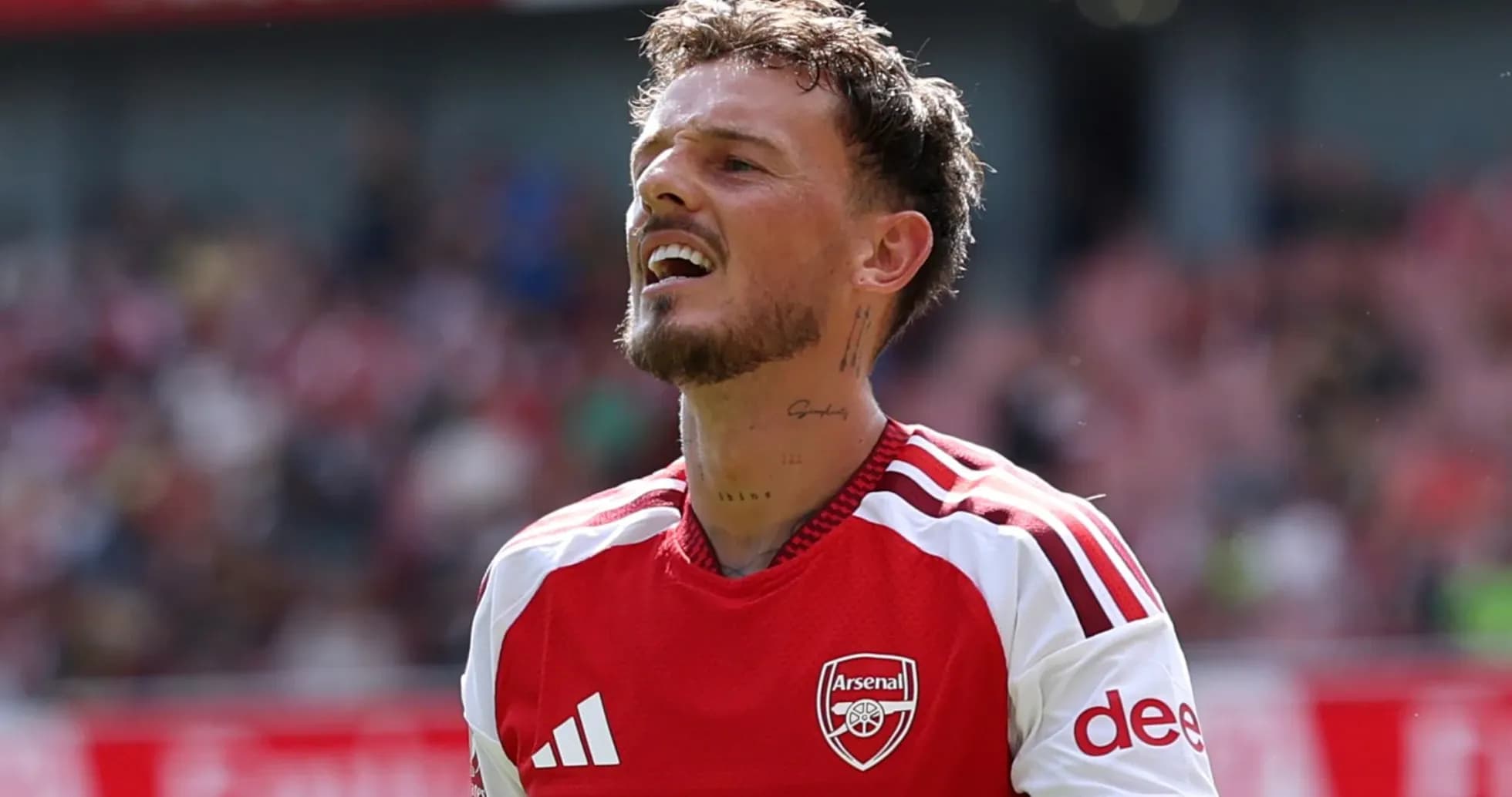 Player in Arsenal jersey reacting during match