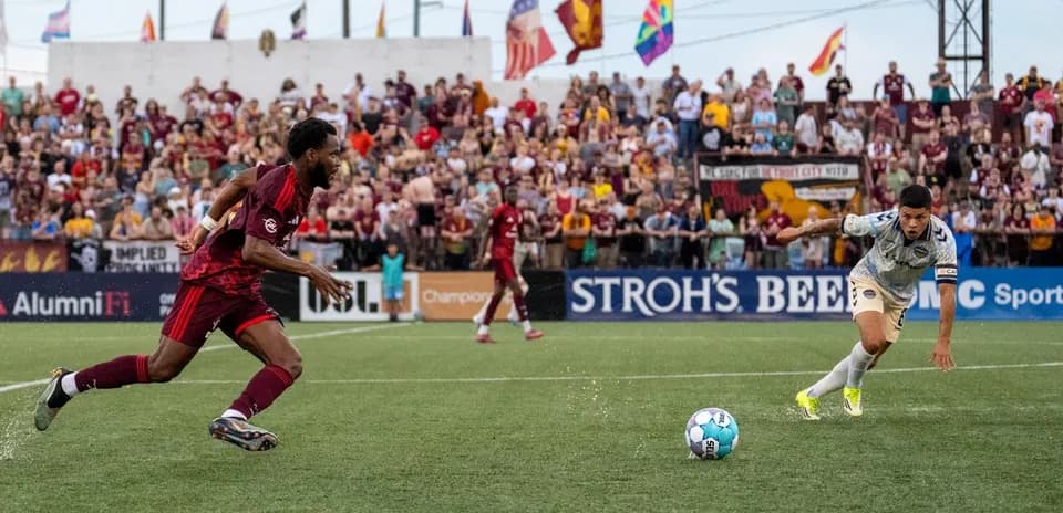 Detroit City player chasing the ball during match