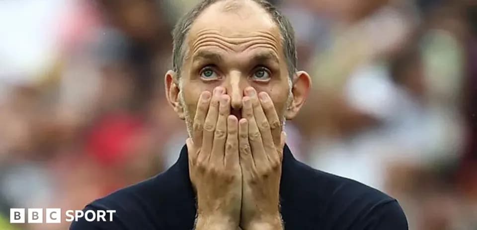 Coach with hands on face during match