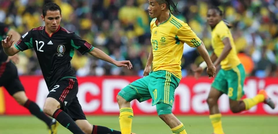 Player dribbling past opponent during soccer match