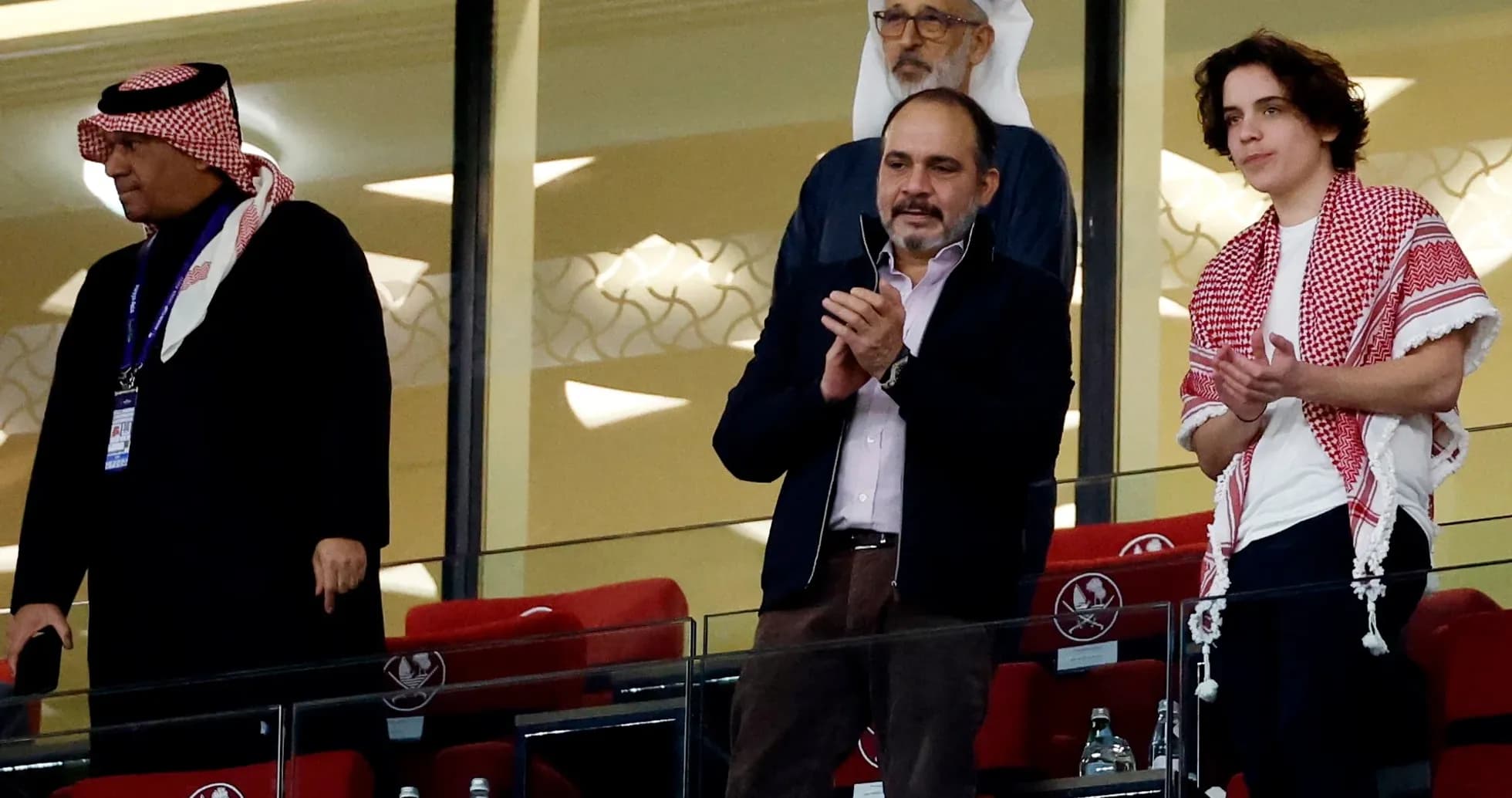 Group of men applauding in a stadium box