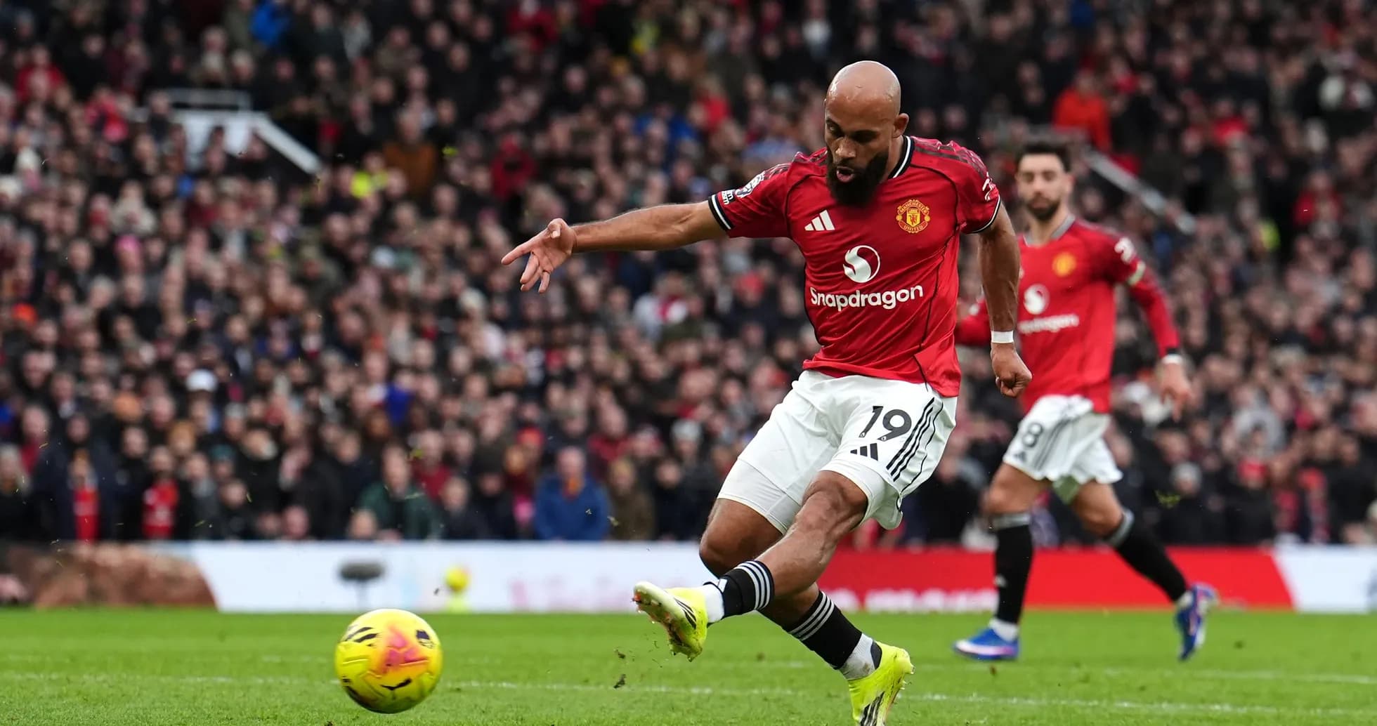 Player kicking ball during Manchester derby