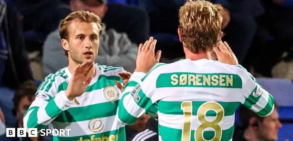 Celtic players exchanging a high-five during match