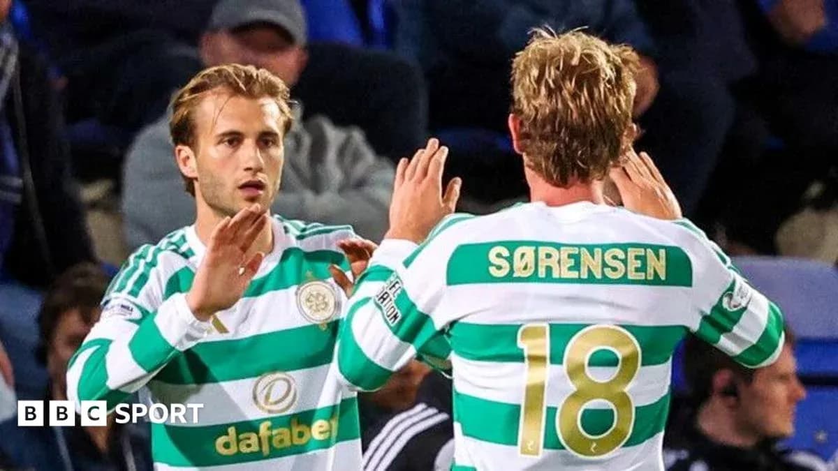 Celtic players exchanging a high-five during match