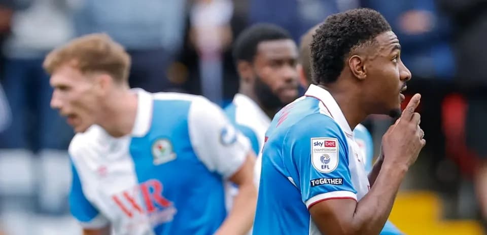 Blackburn Rovers players celebrating a goal on pitch