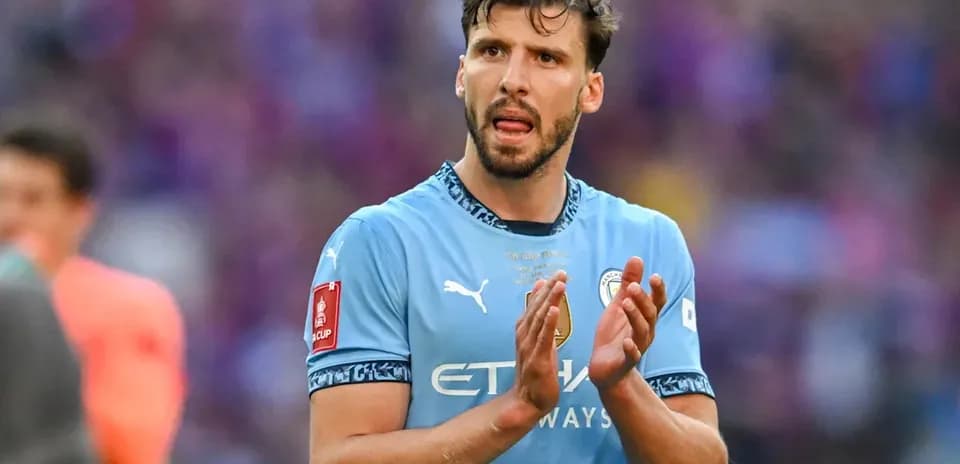 Player in Manchester City kit applauding fans
