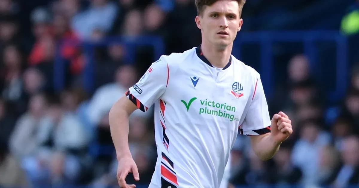Player in white kit running on the pitch