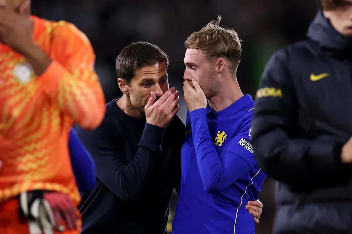 Coach and player discussing on the pitch after match
