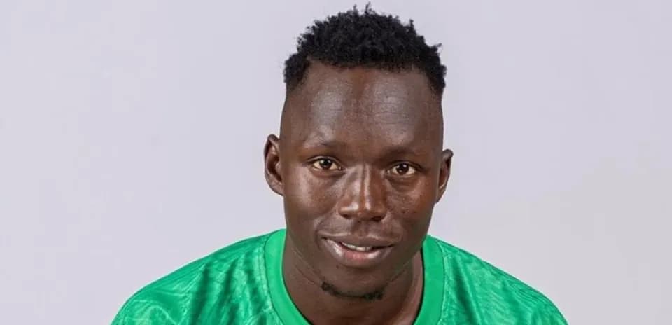 Player in green jersey smiling for portrait
