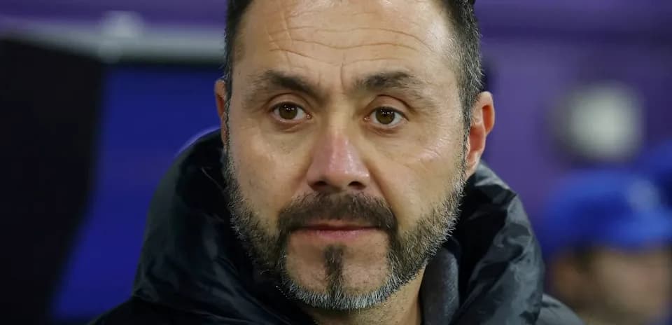 Coach observing during a match from the sidelines