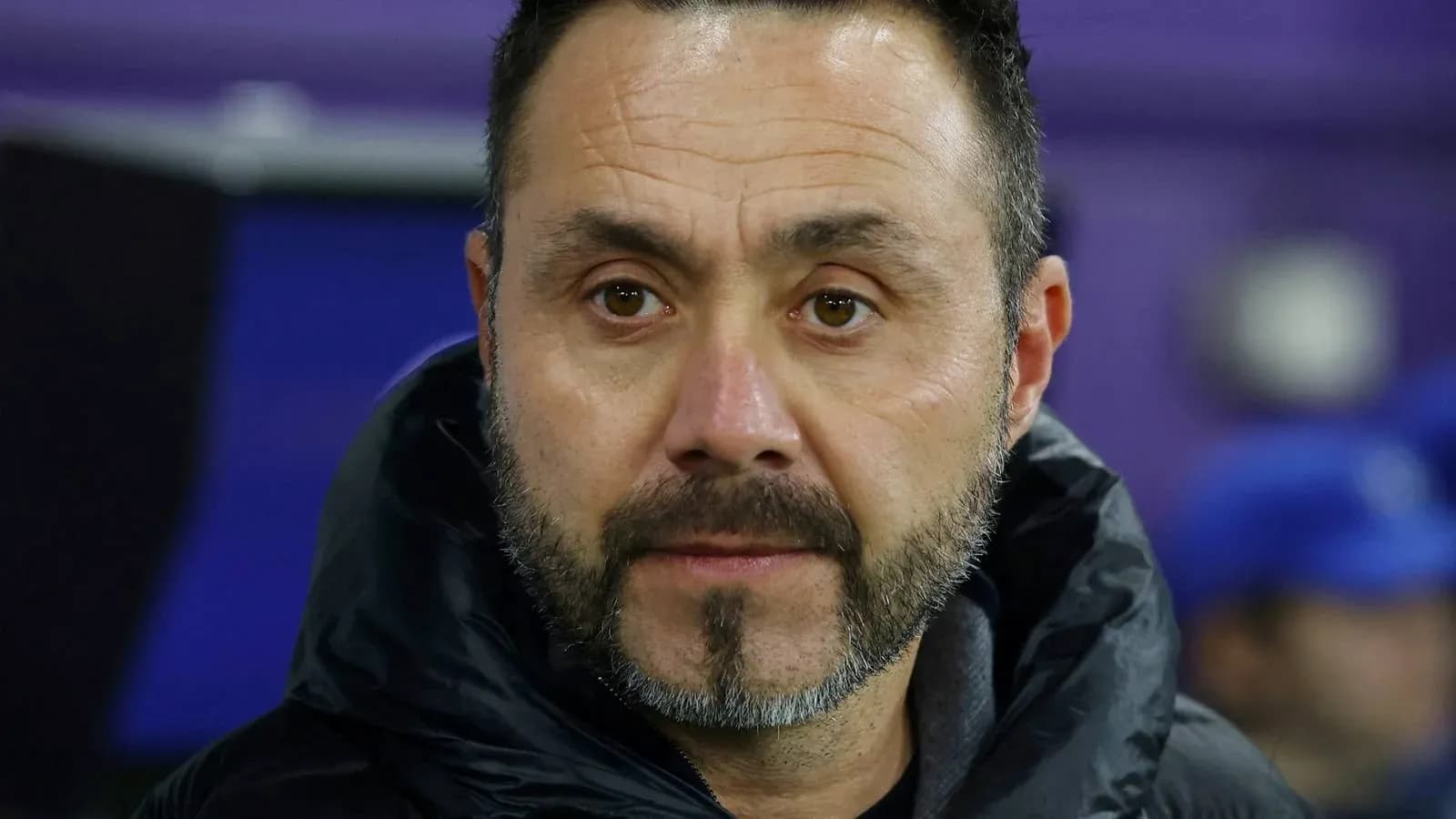 Coach observing during a match from the sidelines