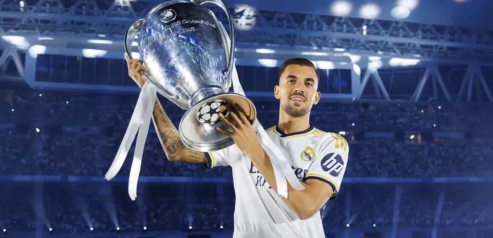 Player holding UEFA Champions League trophy in stadium