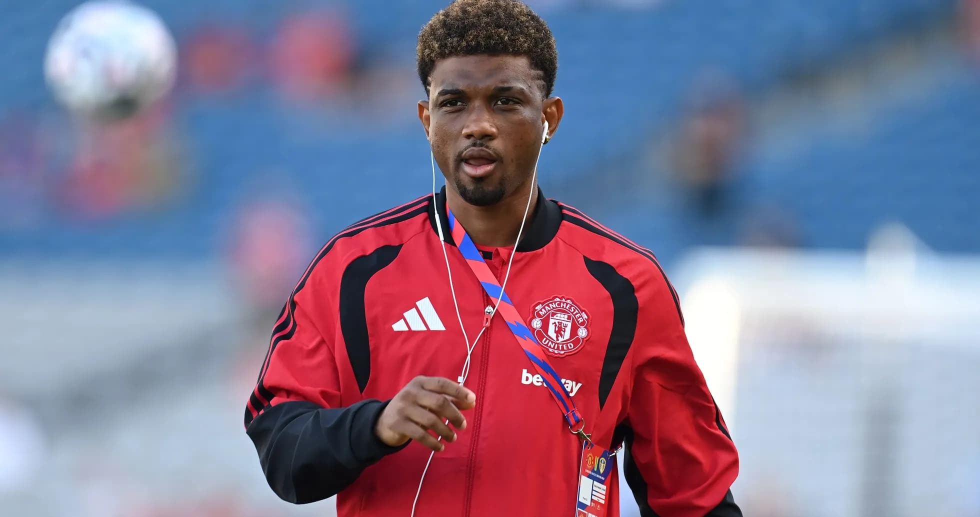 Player walking on the pitch in Manchester United kit