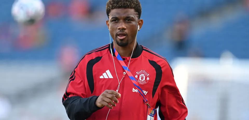 Player walking on the pitch in Manchester United kit