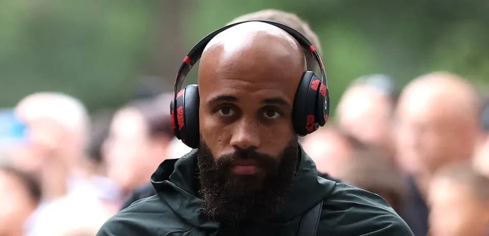 Player walking with headphones before match