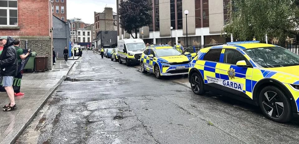 Multiple Garda vehicles parked on a city street