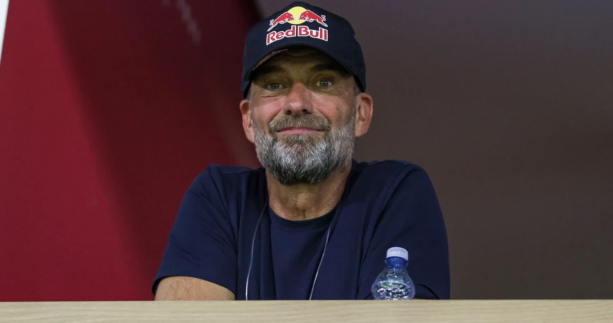Man in a Red Bull cap watching an event