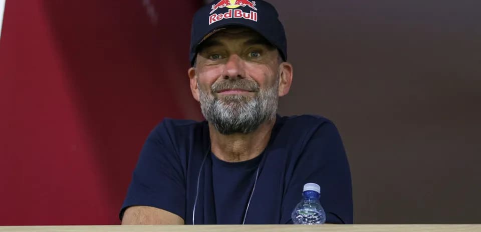 Man in a Red Bull cap watching an event
