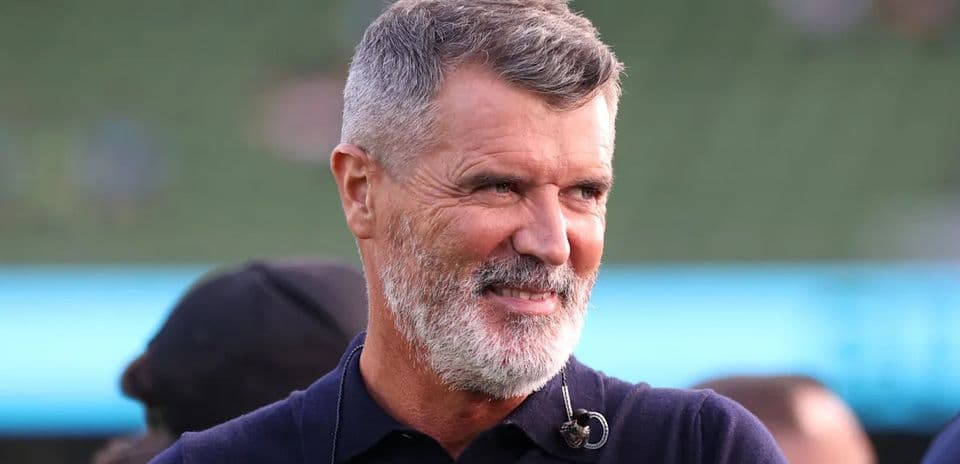 Man with gray beard smiling at an event