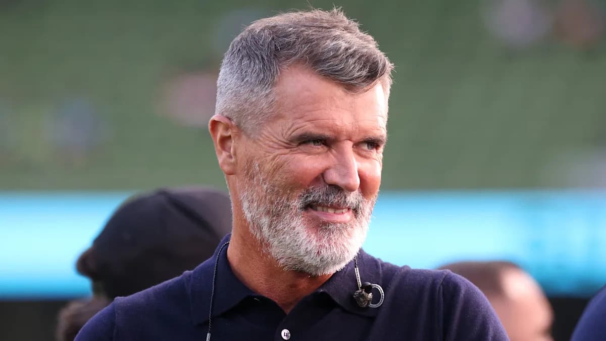 Man with gray beard smiling at an event