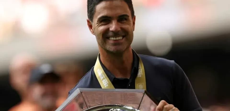 Coach holding trophy during celebratory event