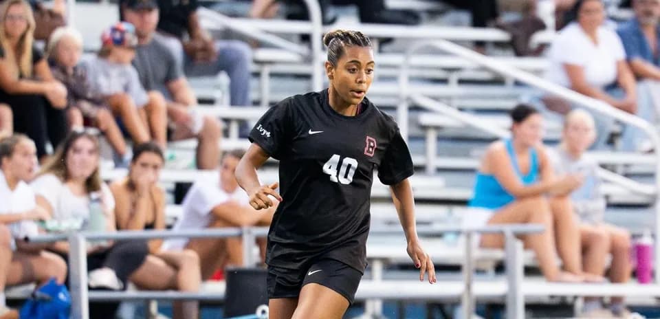 Player in black jersey running on soccer field