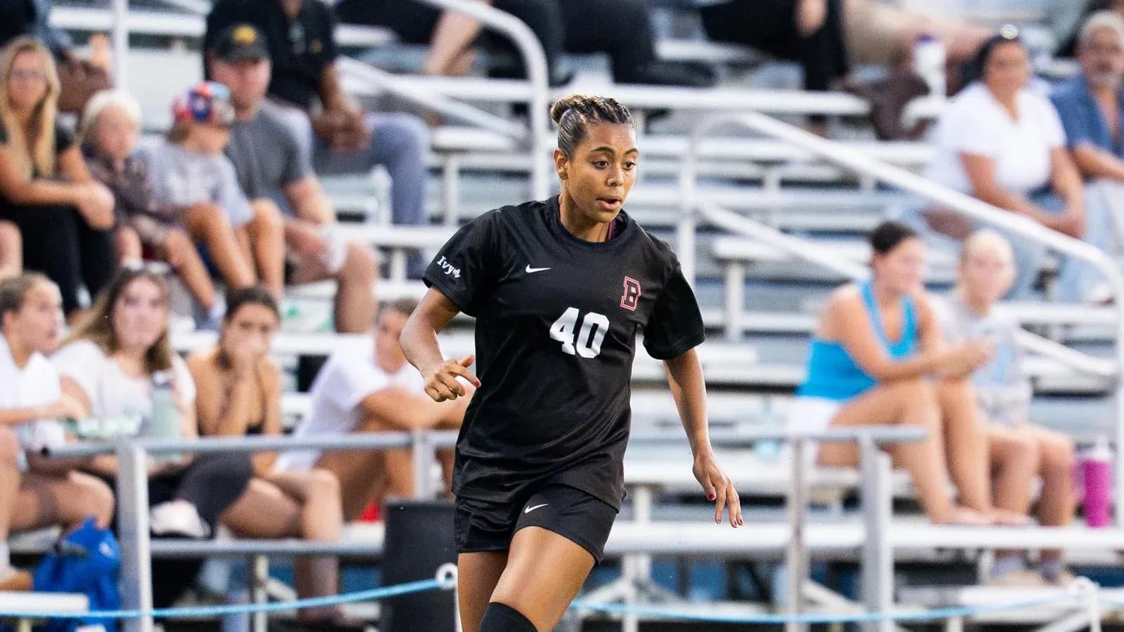 Player in black jersey running on soccer field