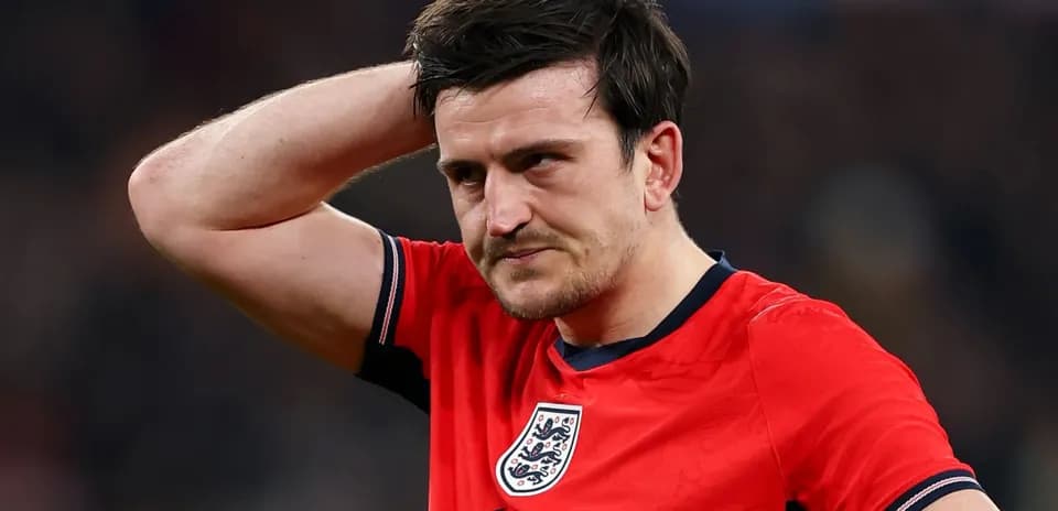 Player in red jersey looks concerned during match