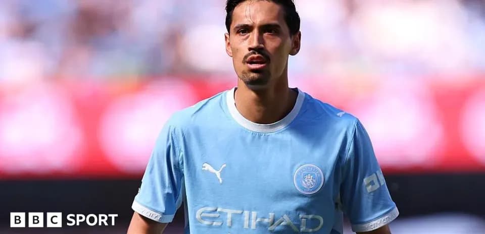 Player in light blue Manchester City jersey on field