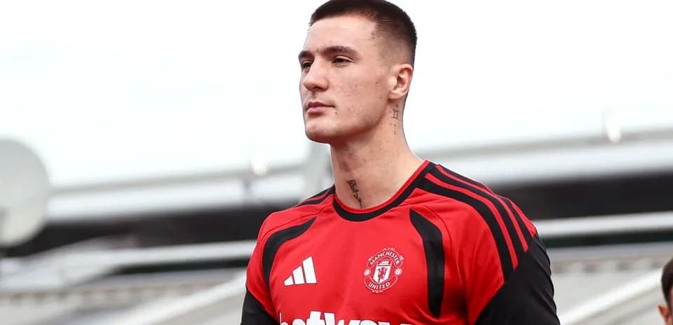 Player in Manchester United training kit on field