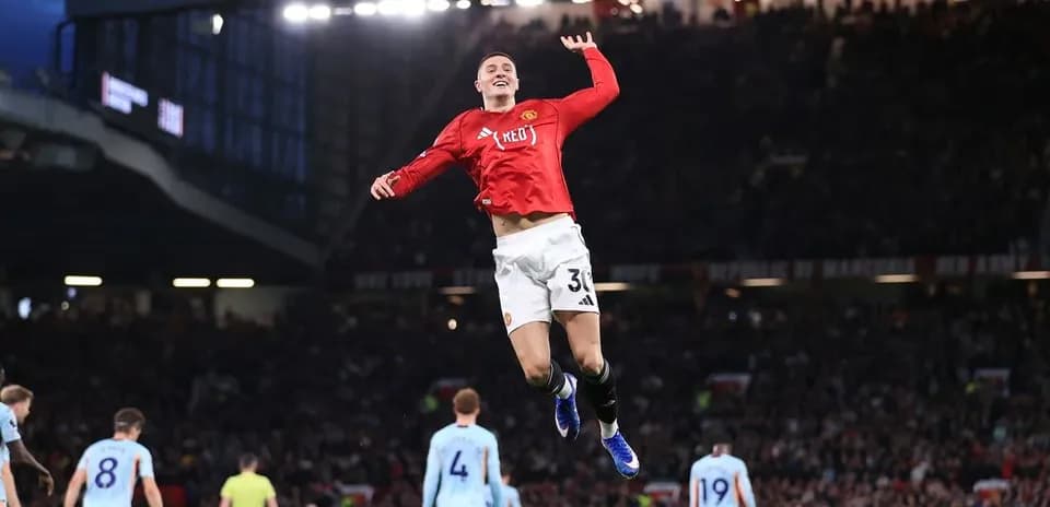 Player celebrating goal during Manchester derby match