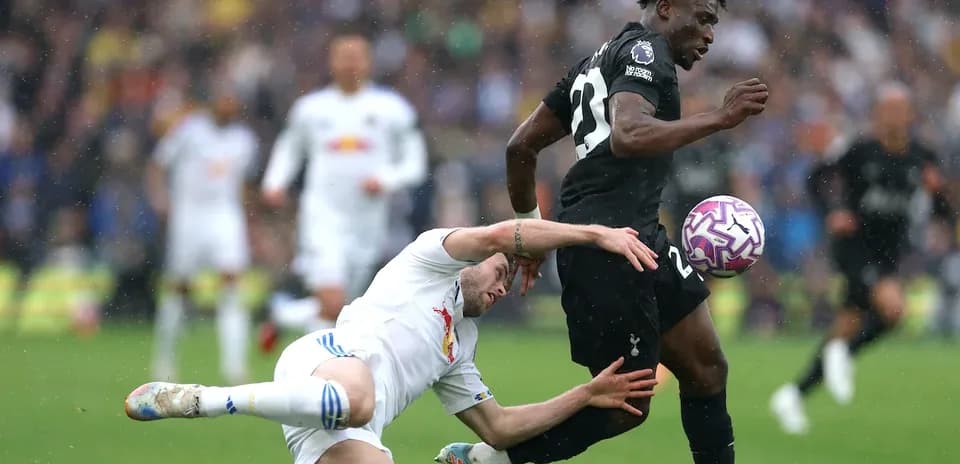 Player tackling opponent during intense football match