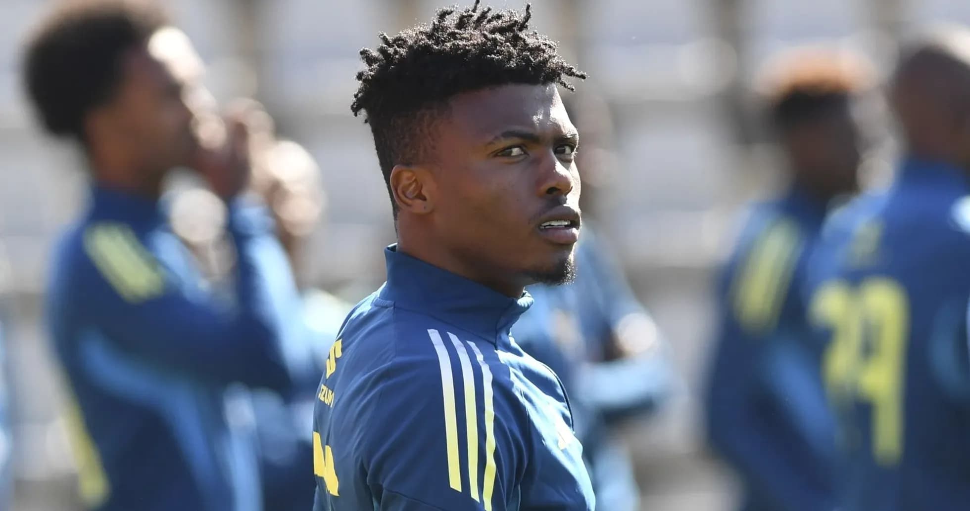 Player focused during training session with teammates