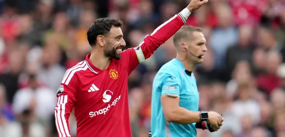 Bruno Fernandes celebrating with referee during match
