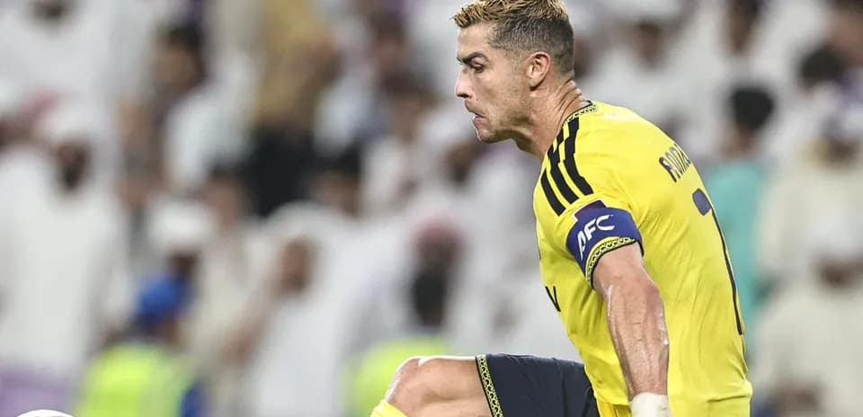 Player in yellow jersey preparing to kick the ball