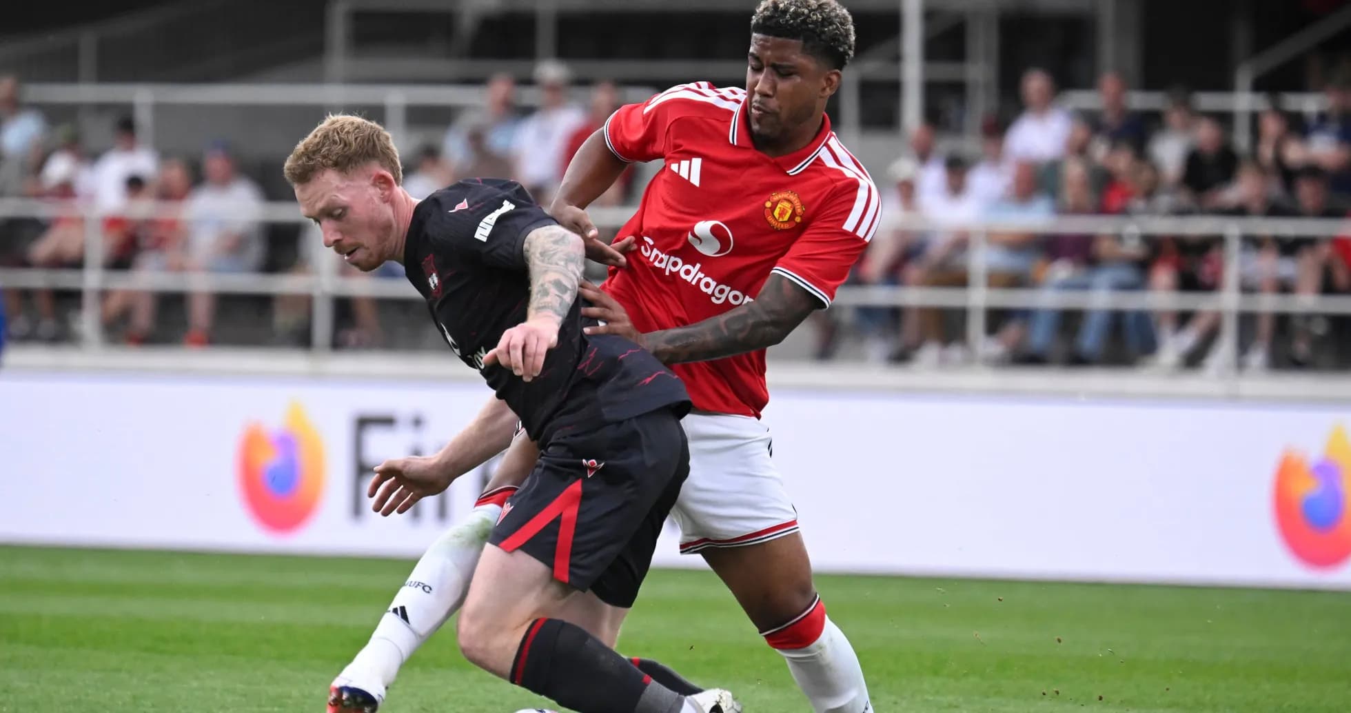 Player tackling opponent during football match