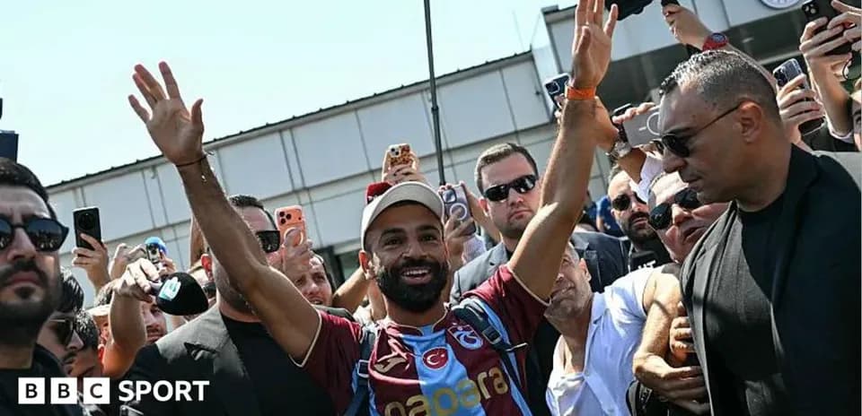 Player greeting fans at airport arrival event