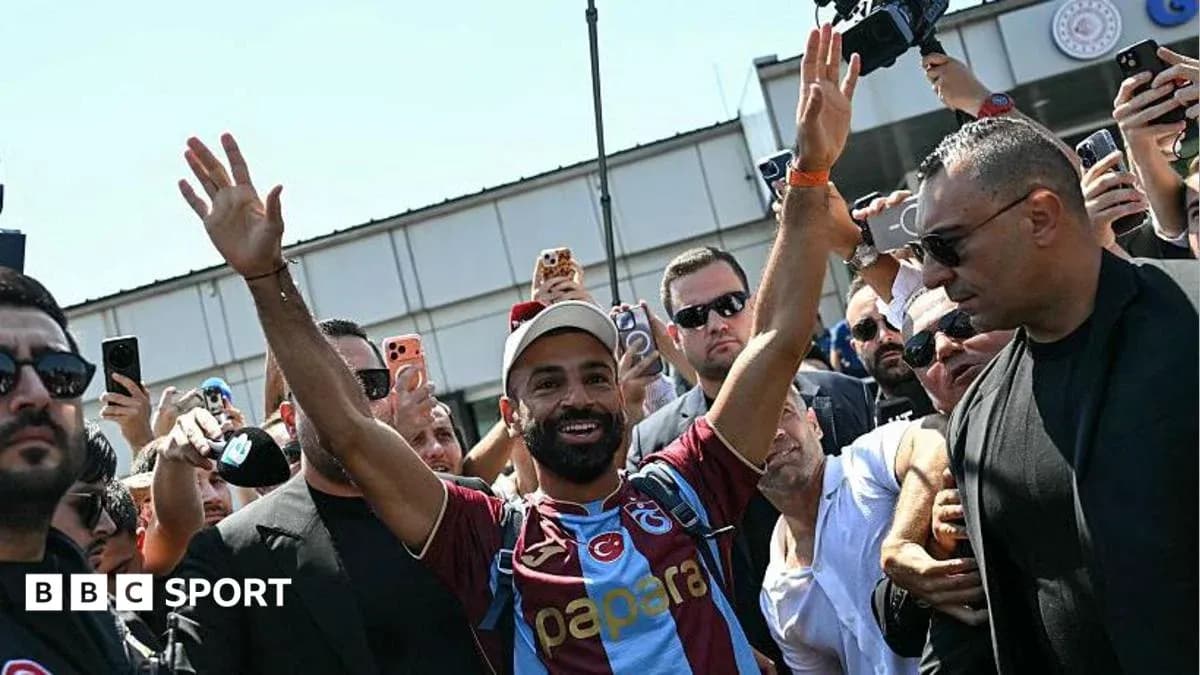Player greeting fans at airport arrival event