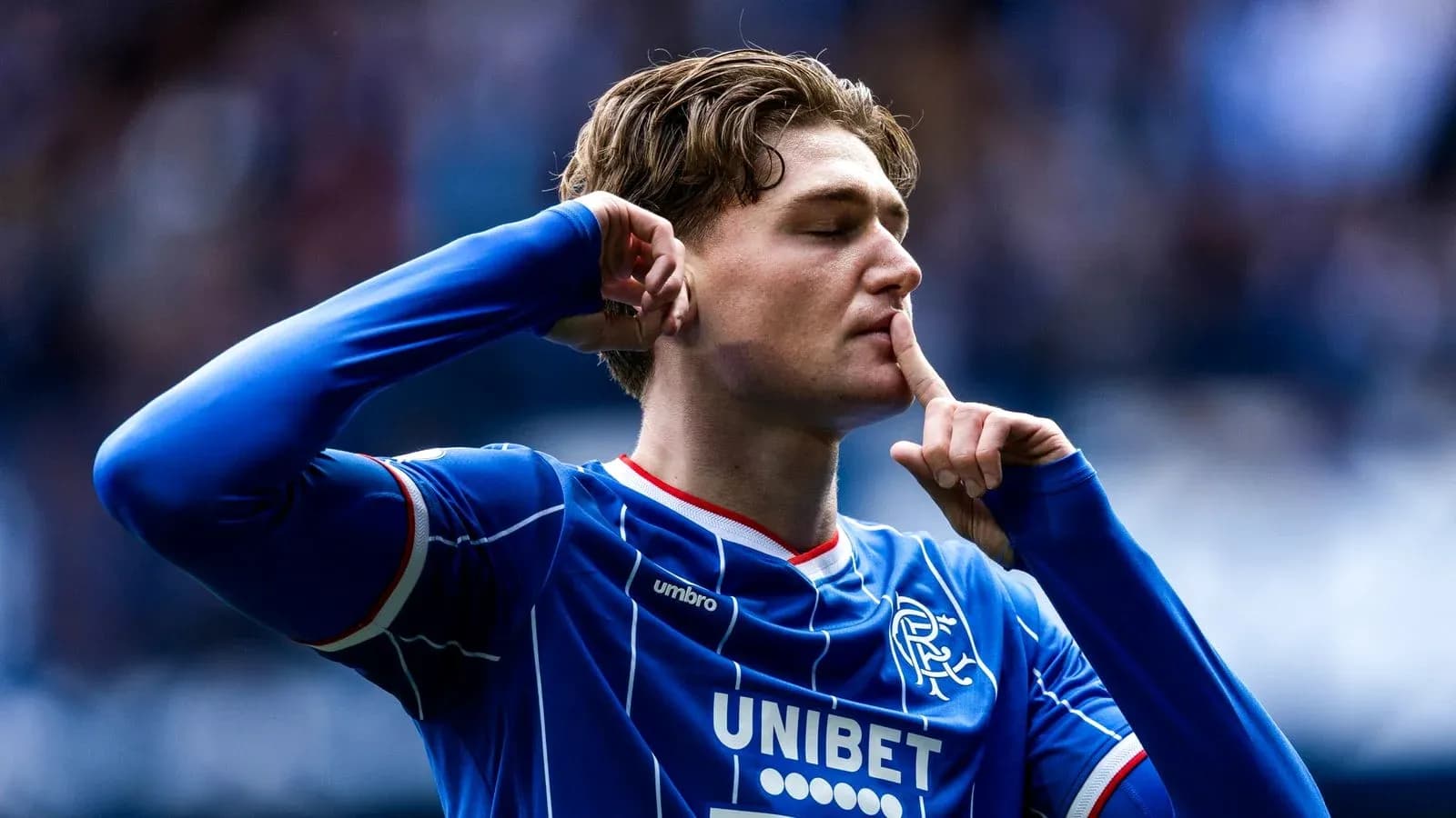 Player celebrating with a shushing gesture