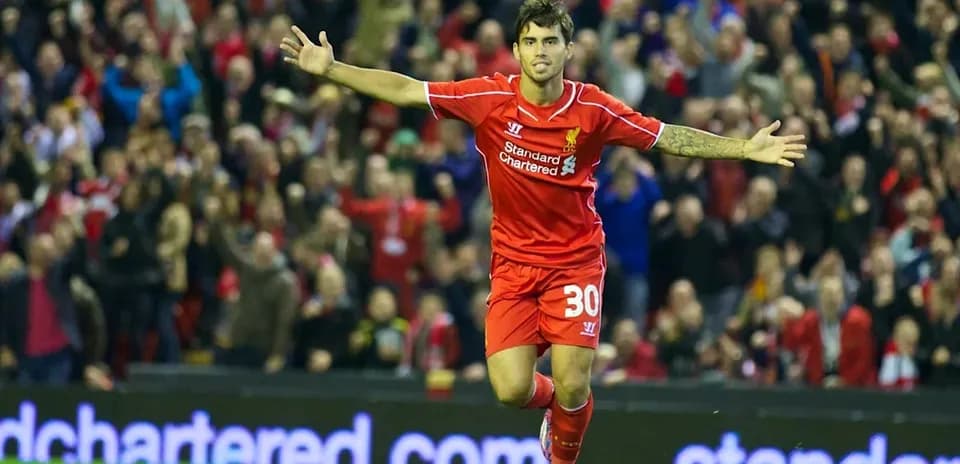Player celebrating goal in Liverpool jersey at stadium