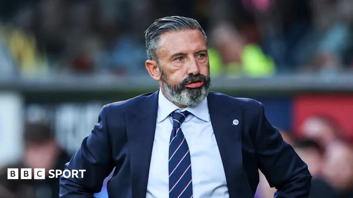 Manager standing on the sidelines during a match