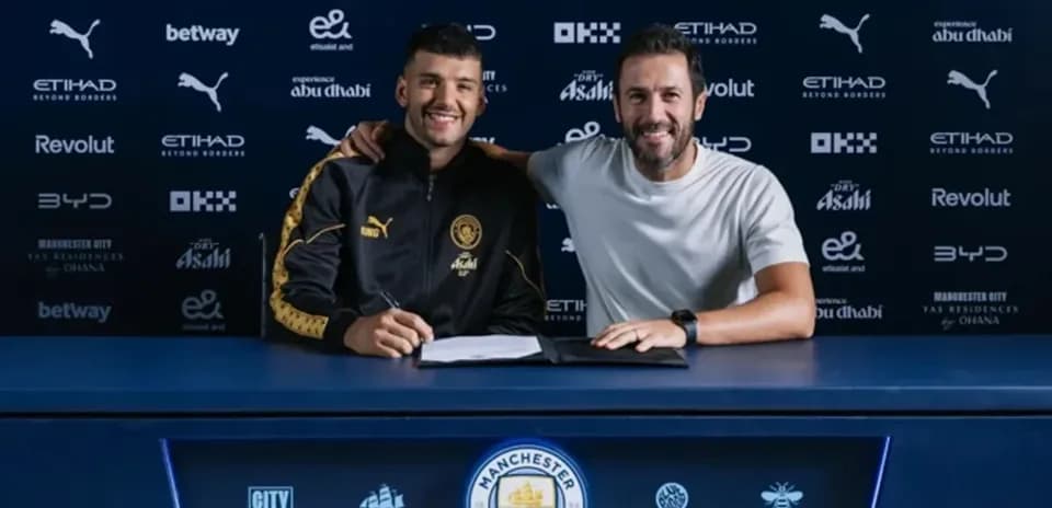 Player signing contract with manager at table