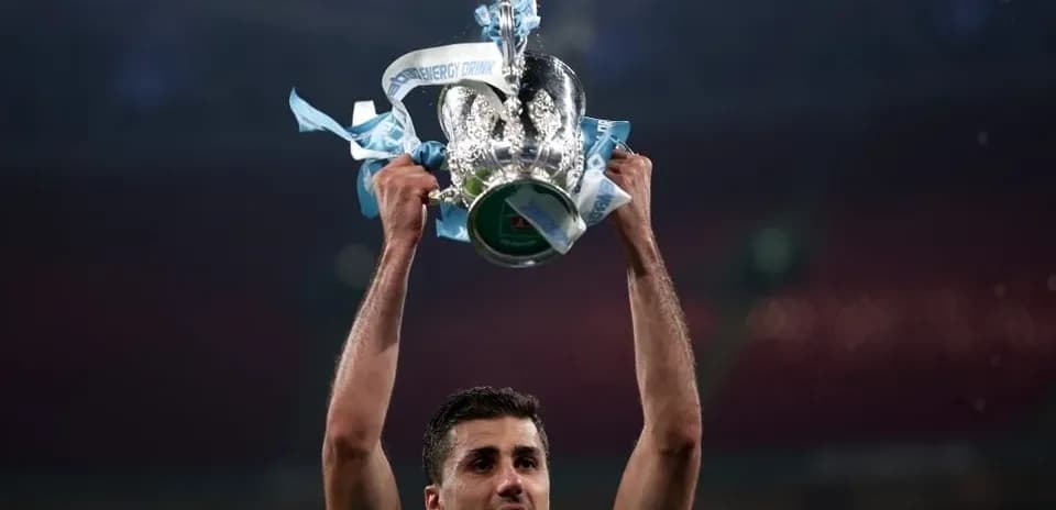 Player holding trophy aloft in celebration