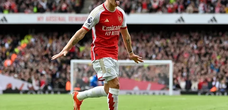 Arsenal player celebrating a goal in stadium